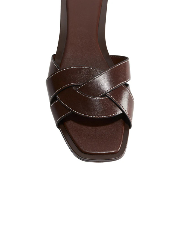 Luxury dark brown cross strap flat slippers for women with square toe, elegant minimalist slip-on sandals for casual wear.
