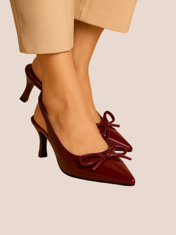 Maroon Dira Slingback Bow Pumps with glossy patent leather finish, pointed toe design, and adjustable slingback strap, featuring a decorative bow detail at the front, high stiletto heel.