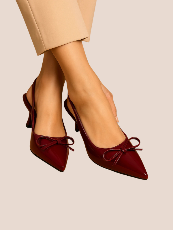 Maroon Dira Slingback Bow Pumps with glossy patent leather finish, pointed toe design, and adjustable slingback strap, featuring a decorative bow detail at the front, high stiletto heel.